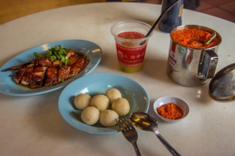 Rice balls with duck and sour plum juice. Huge sambal container on the right.